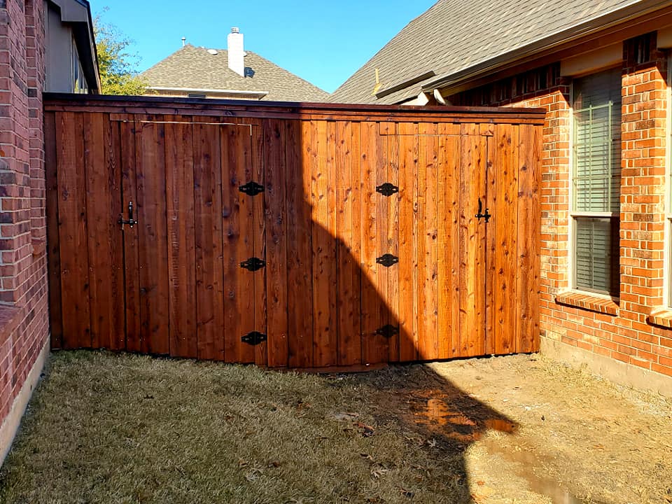 "A stunning cedar fence featuring a vertical design, standing tall at 8ft, surrounded by greenery, adding charm and privacy to the backyard space. Fence
